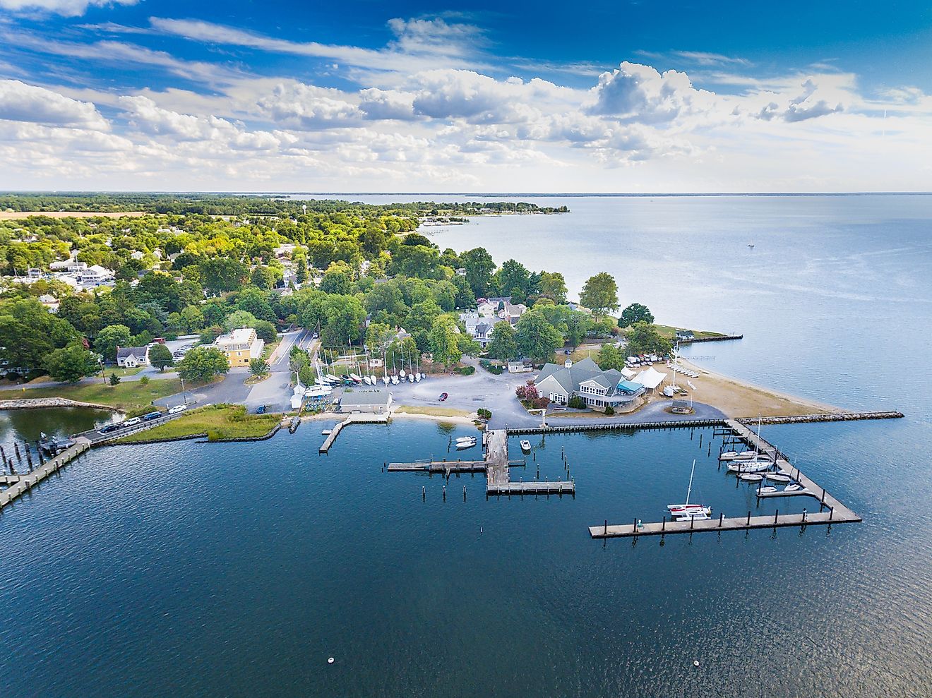 Aerial view of Oxford, Maryland, situated on the Chesapeake Bay, showcasing clouds, water, and shoreline.