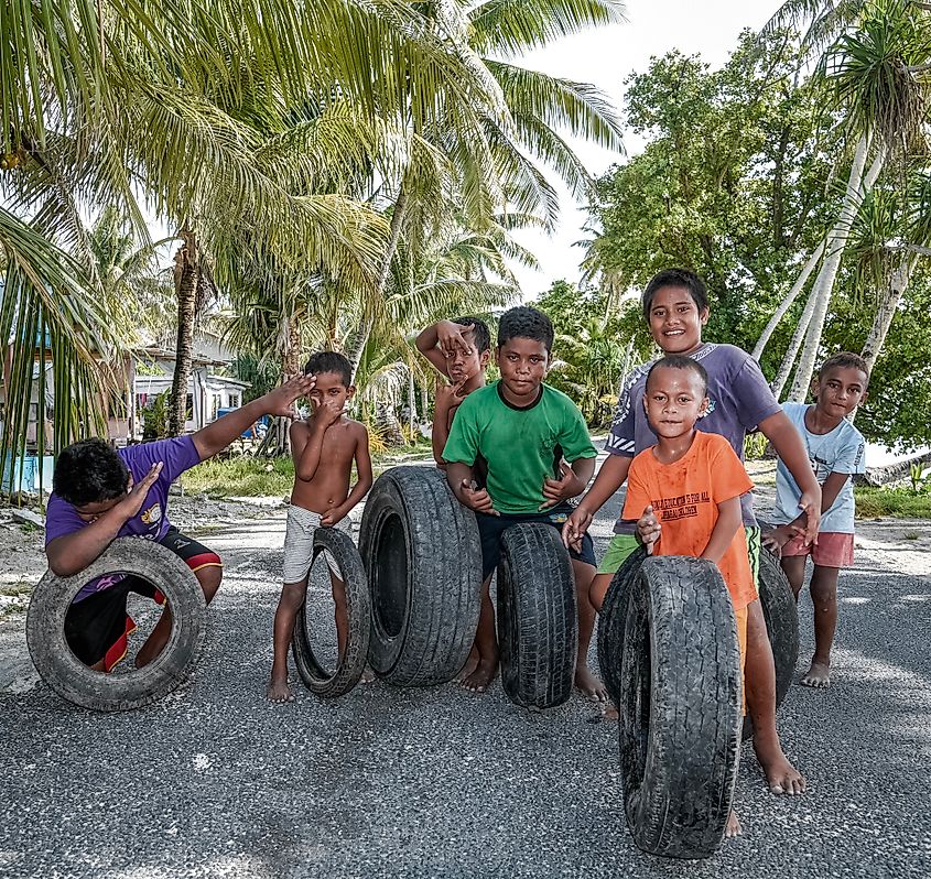 Kids playing in the street on the island of Tuvalu. Editorial credit: Romaine W / Shutterstock.com